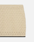 The Bauble Skirt by FRAME is a beige knit skirt featuring a bauble texture and subtle repeating pattern. Displayed against a white background, only the upper portion of the skirt is visible.