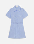 The Striped Safari Dress by FRAME is crafted from crisp cotton poplin with white vertical stripes, front buttons, two chest flap pockets, and a matching thin waist belt—ideal as a breezy summer dress.