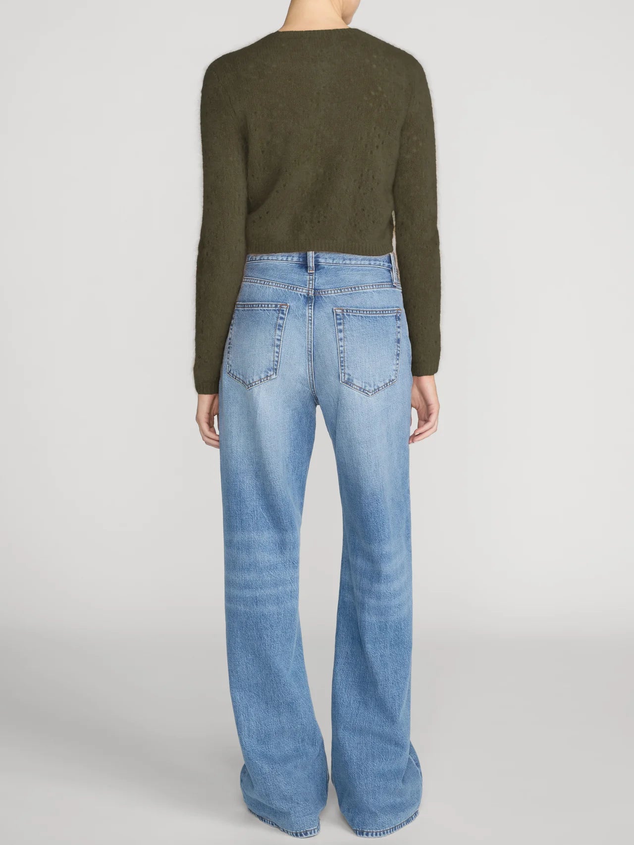 FRAME The Cashmere Airy Cardi sweater in ivory with light blue wide-leg jeans on a minimal background.