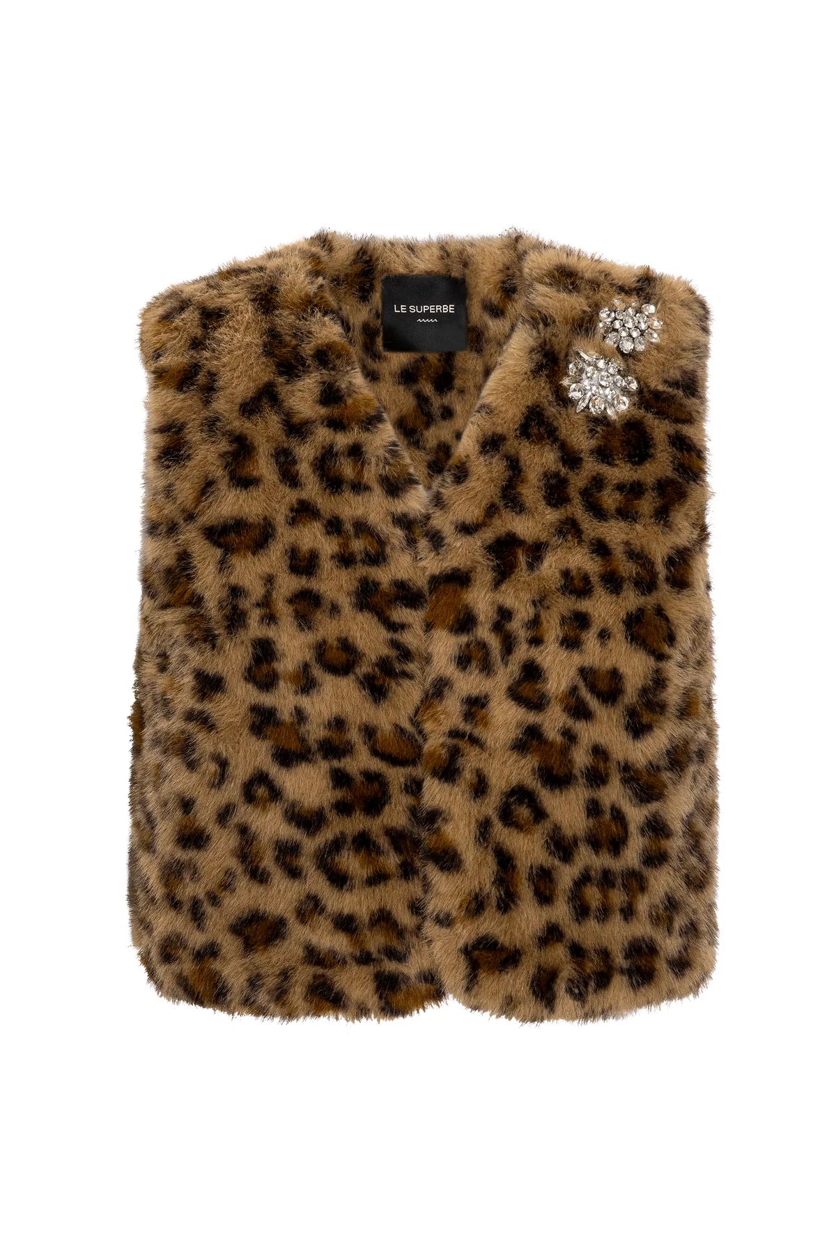 The Le Superbe Treasure Vest is a cropped faux fur vest featuring a brown and black leopard print and two jeweled brooches on the left shoulder.