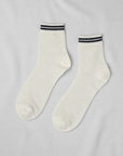 Unified Mesh Sneaker Socks in white feature black and white striped cuffs. Crafted from breathable cotton, these short crew ankle socks are displayed flat on a light gray background.