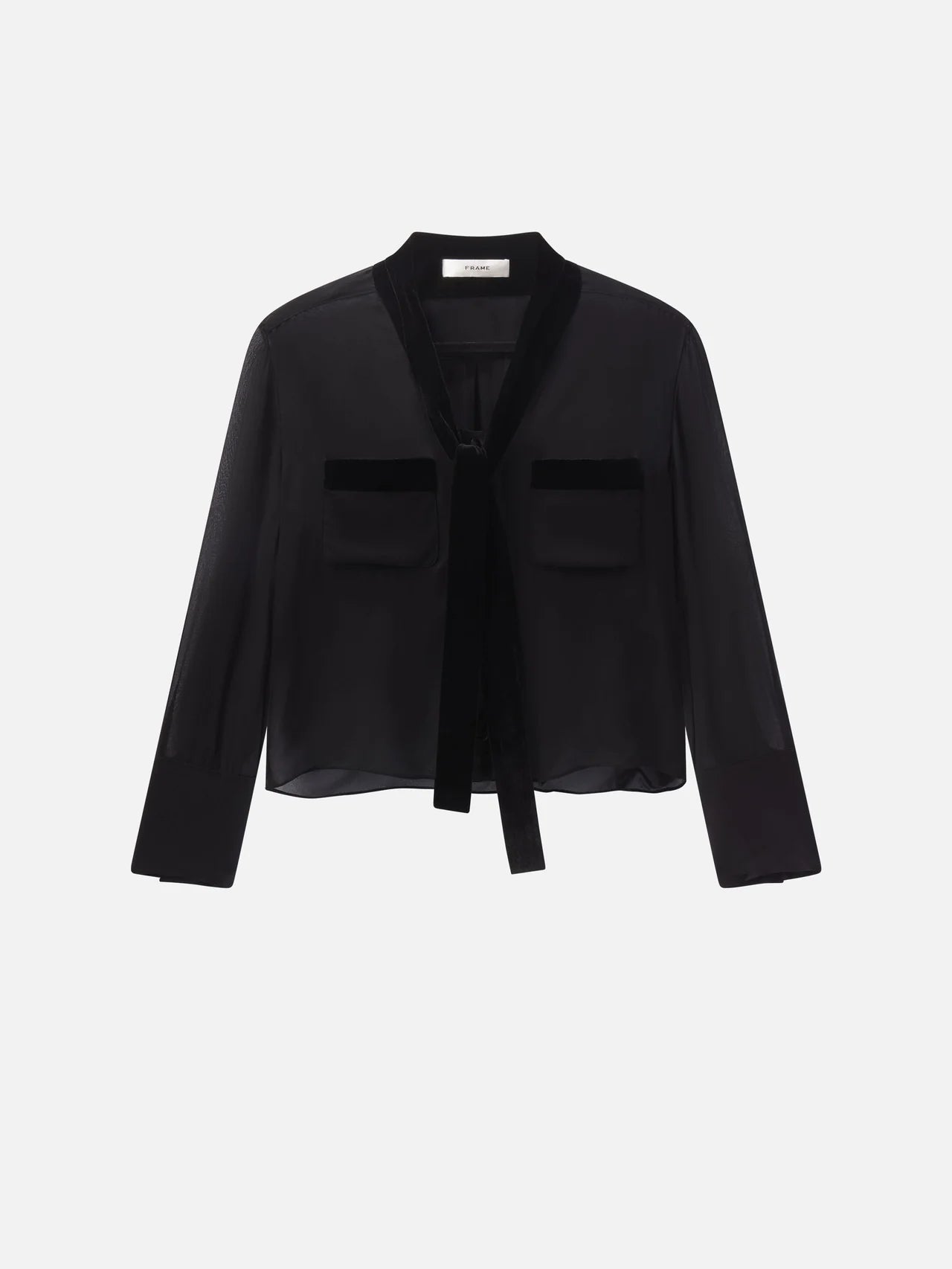 The Velvet Trim Modern Tie Blouse by FRAME is a sheer black silk top with velvet trim, tie-neck detail, two chest pockets, and a relaxed fit, shown against a white background.