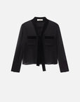 The Velvet Trim Modern Tie Blouse by FRAME is a sheer black silk top with velvet trim, tie-neck detail, two chest pockets, and a relaxed fit, shown against a white background.