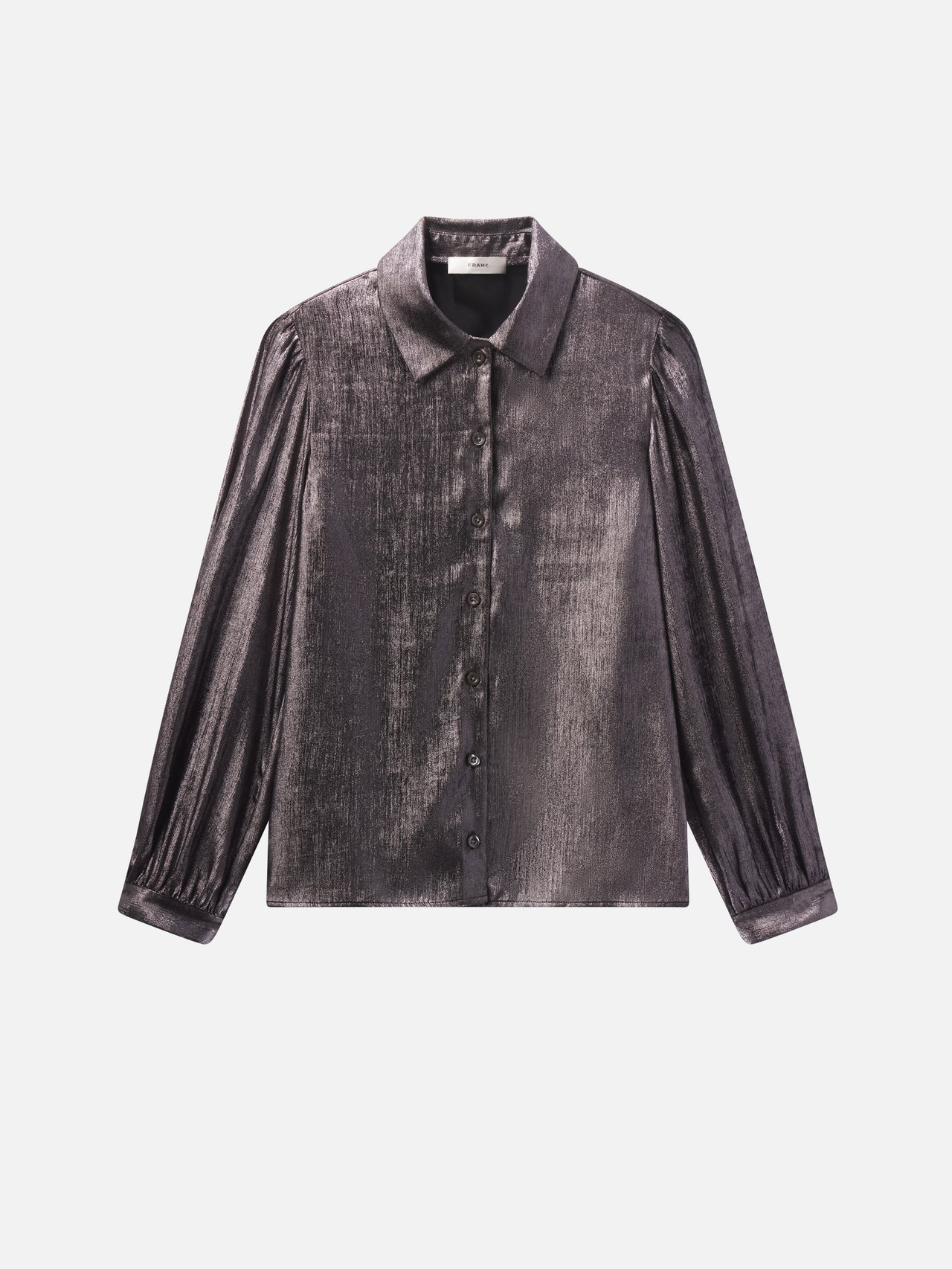 The Shiny Staple Blouse by FRAME is a long-sleeve, button-up metallic silver shirt with a classic collar and subtle shoulder puff, creating a striking silhouette against a plain white background.