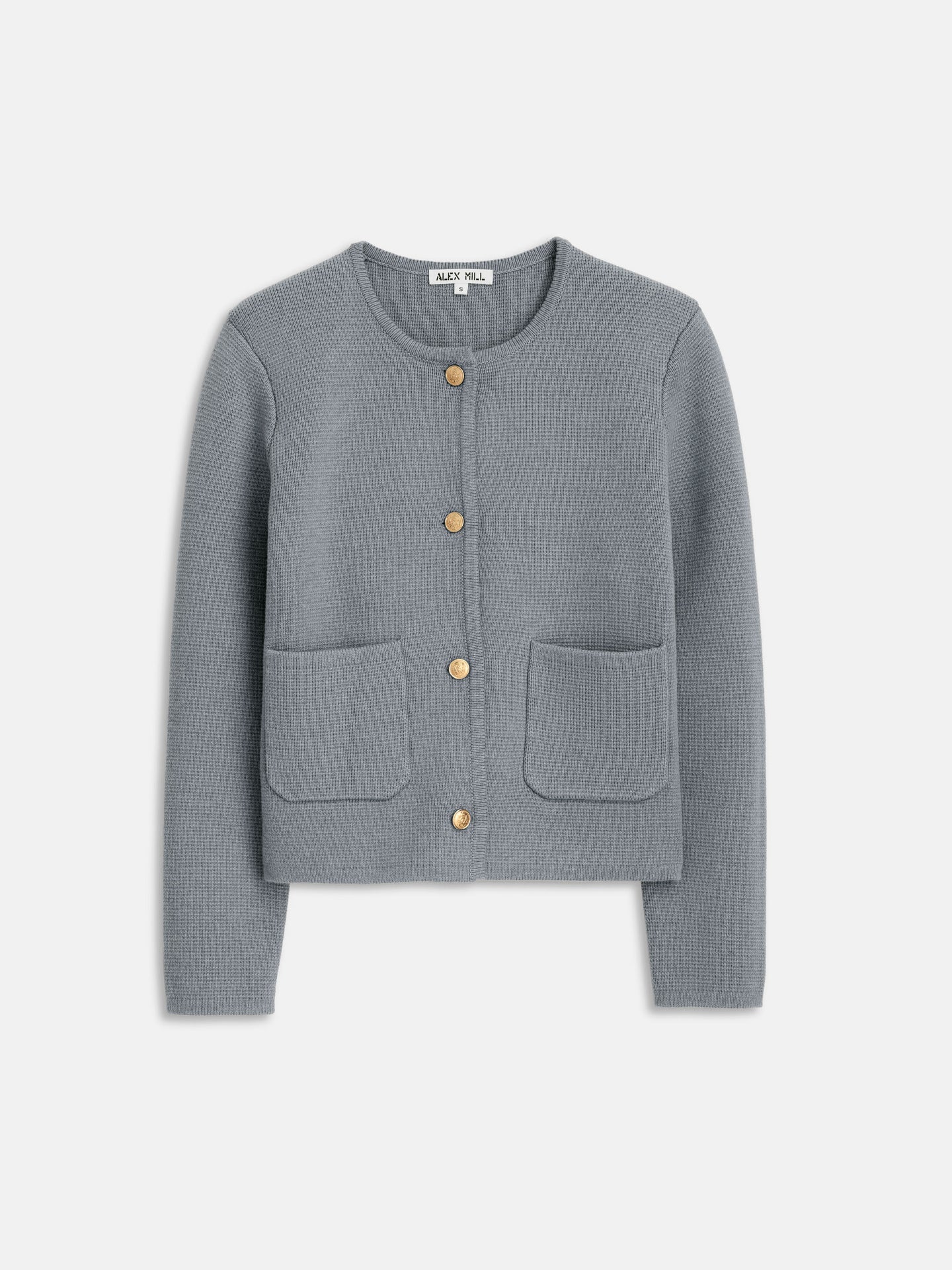 The Paris Sweater Jacket by Alex Mill is a light gray, textured cardigan in a soft cotton-cashmere blend. It features long sleeves, a round neckline, five brass crest buttons down the front, and two stylish square pockets.