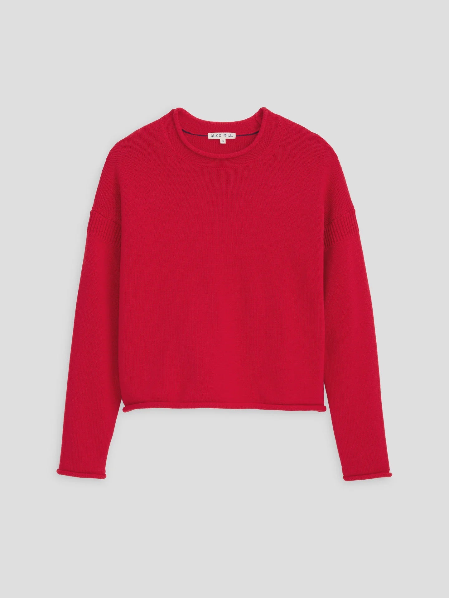 The Mariner Rollneck by Alex Mill is a women's designer knit sweater in red, featuring a relaxed fit with long sleeves and a crew neckline. Made from 100% cotton, it has ribbed detailing on the shoulders and edges, set against a crisp white background.