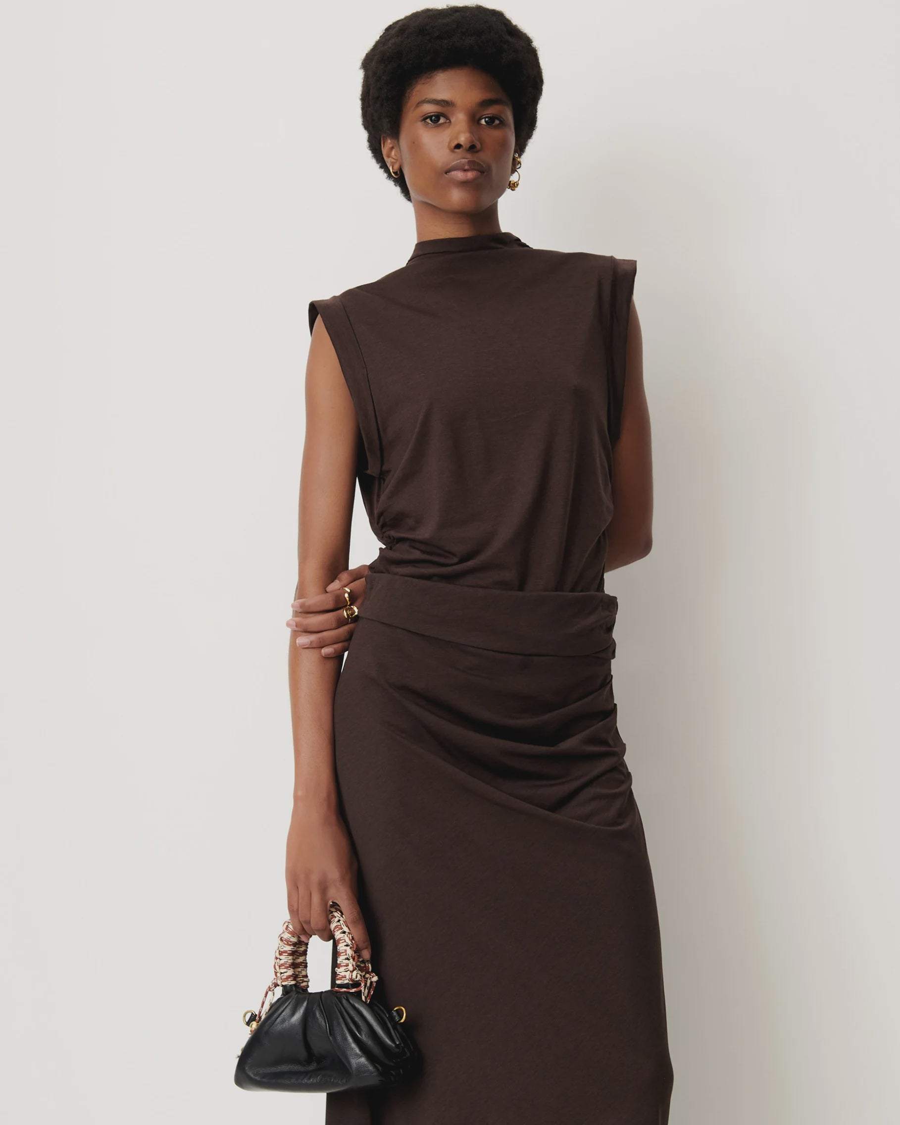 Sessun DATZ short sleeve T-shirt in white styled with a black handbag, shown against a white backdrop.