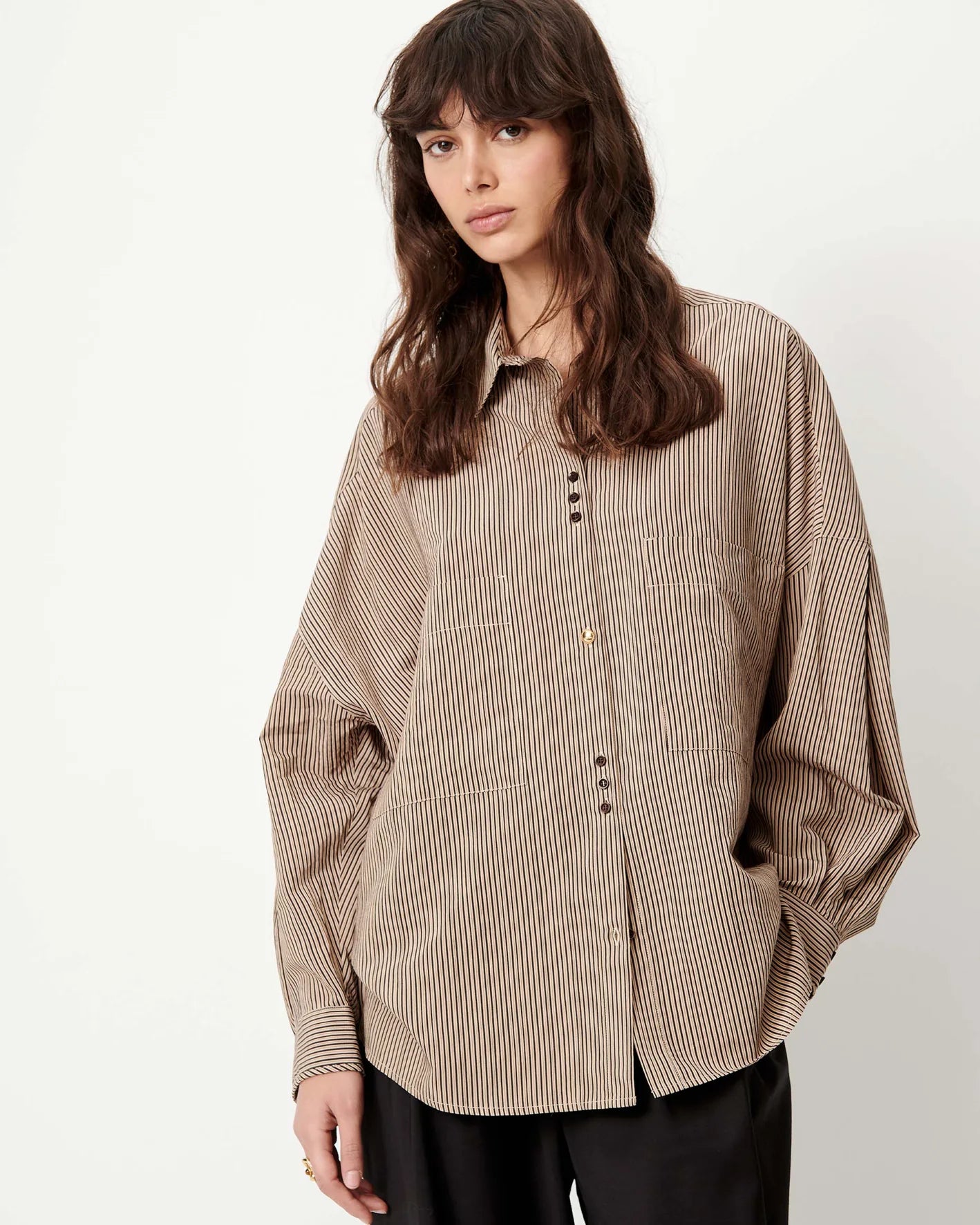 Sessun FONTANIA white button-up shirt with front pockets and long sleeves, shown with black pants.