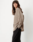 Sessun FONTANIA shirt with front pockets and black pants, model facing left against white backdrop.