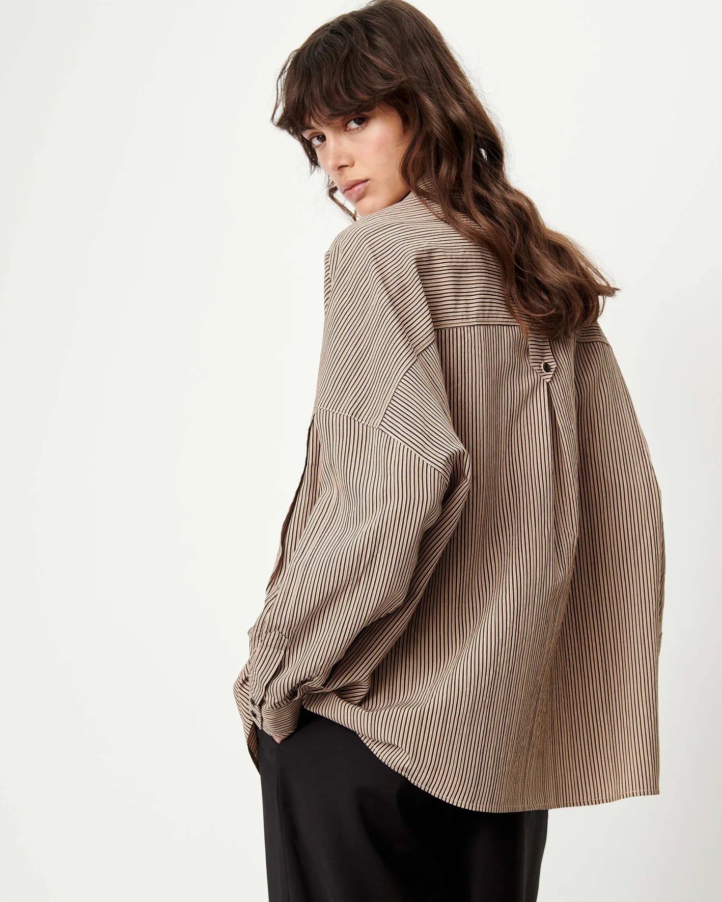 Sessun FONTANIA shirt with front pockets in white, styled with black pants, lifestyle look over the shoulder.