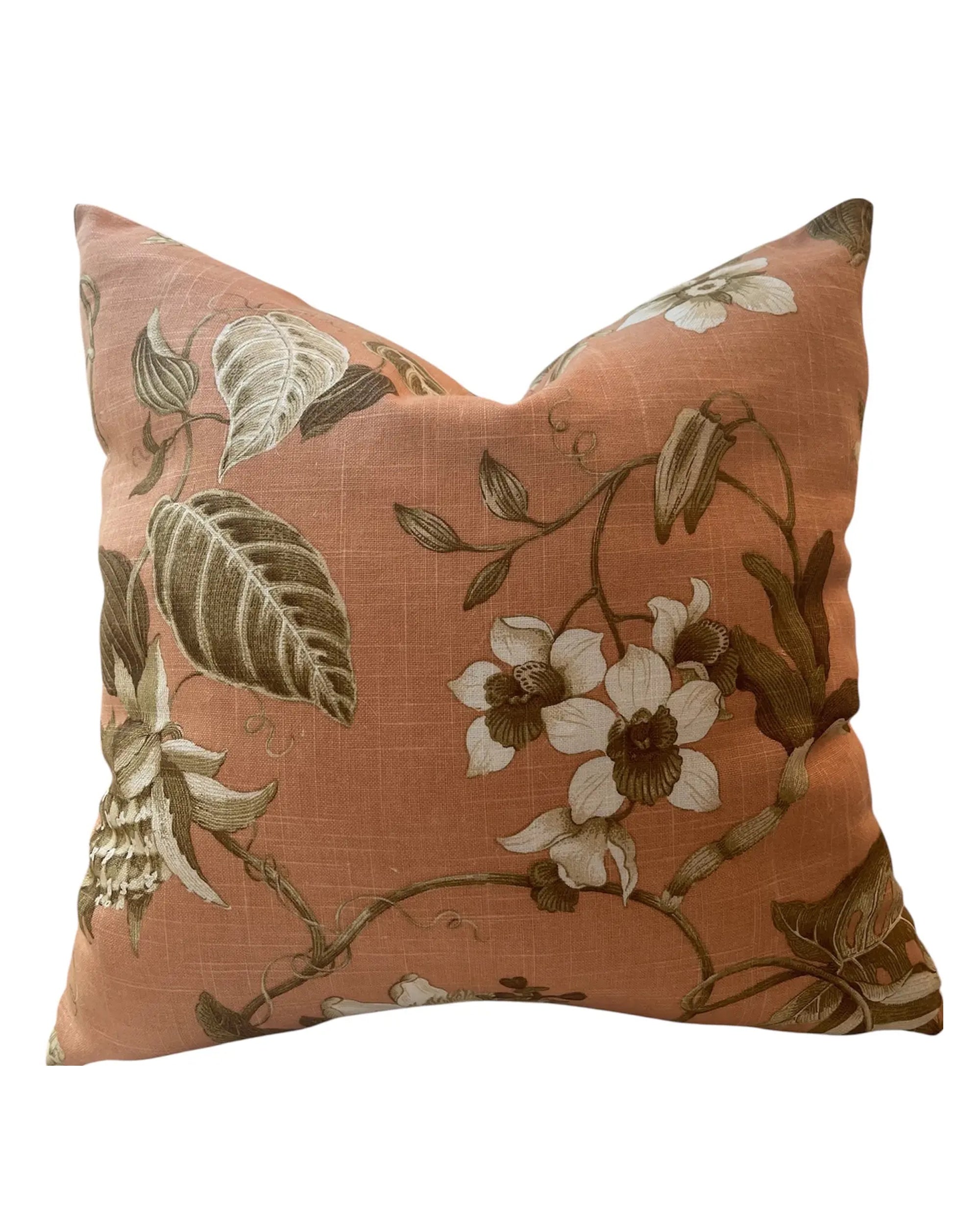 The Whitley Botanical 20x20 Pillow by Dahlia & Grace Pillows features a muted coral background with cream, brown, and light green floral motifs—a stylish cotton accent perfect for adding warmth and elegance to any space.