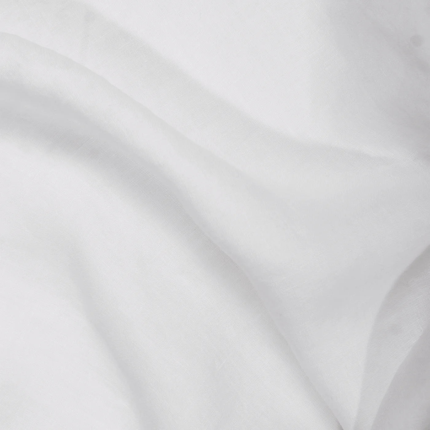 A close-up of the Matteo Tat Cotton Sham highlights its smooth, slightly translucent white fabric with gentle folds, subtle shadows, and a crisp percale weave.