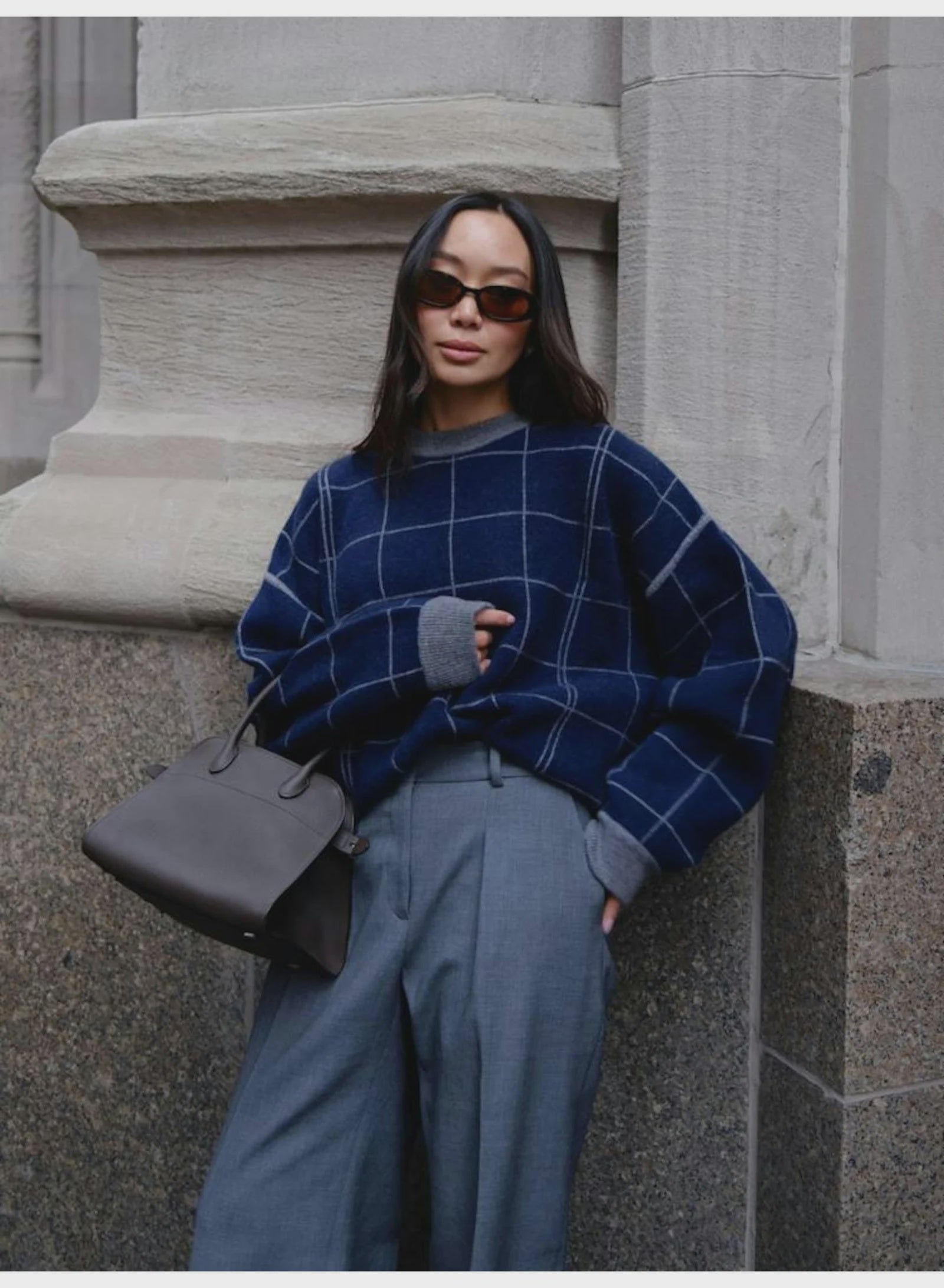 White + Warren cashmere windowpane sweatshirt in stone setting, styled with gray handbag, casual modern look.