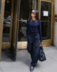 Cashmere contrast collar sweater by White + Warren styled with sunglasses and wide pants outdoors.