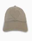 The Imperfect Heart Hat by Kerri Rosenthal is a beige baseball cap made from stone-washed cotton, featuring an Imperfect Heart patch on the front. Its white background highlights the cap's simple and minimalist design.