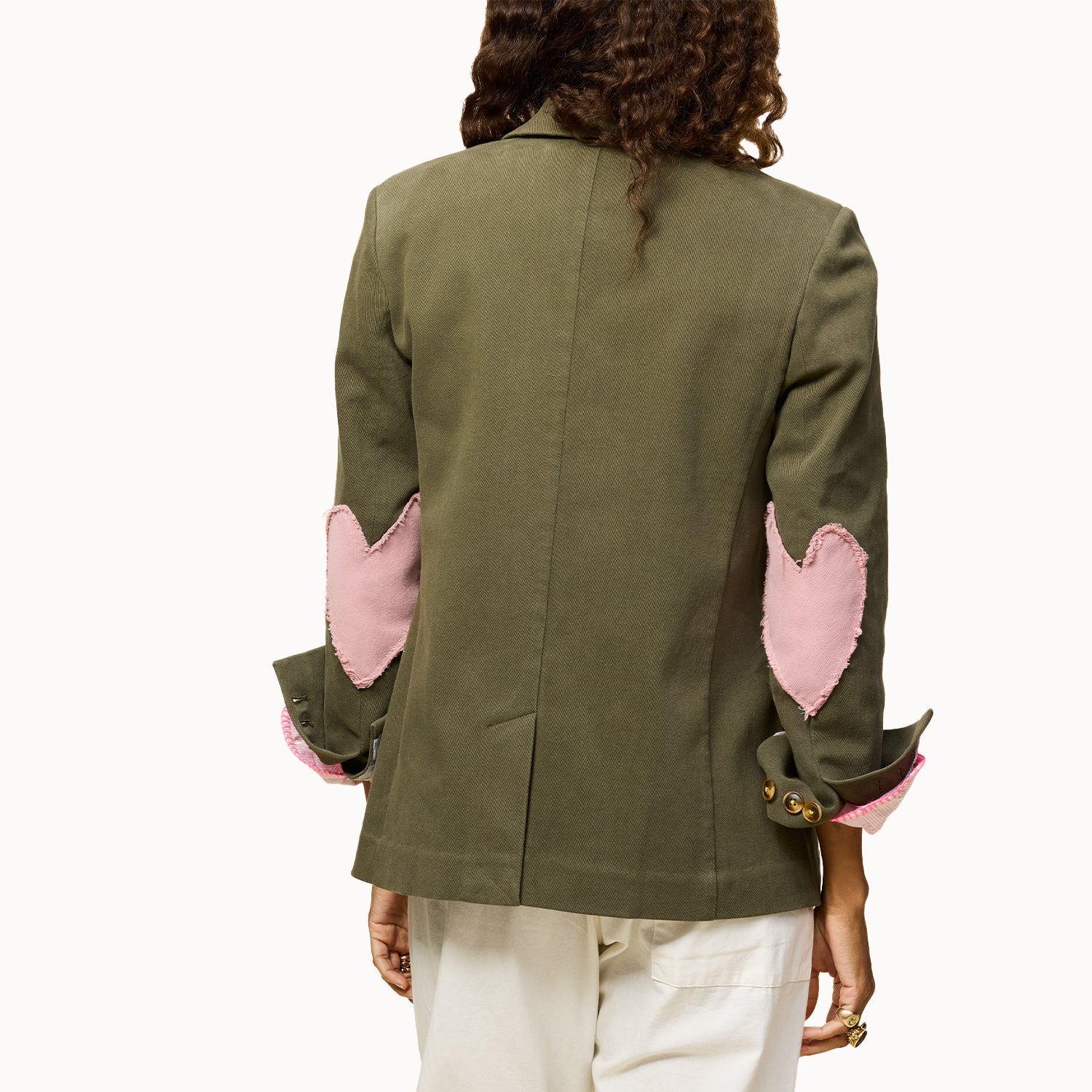 Green blazer with pink heart elbow patches by Kerri Rosenthal, Workday Love Brigade, shown from the back.
