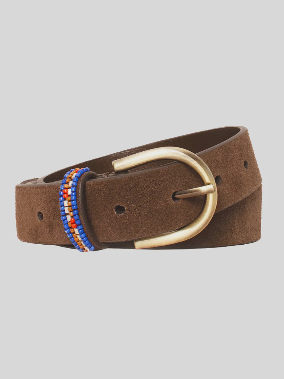 The Xirena Brix Belt is a brown suede leather belt featuring a gold-toned D-shaped buckle and a loop adorned with small blue and orange beads, shown against a light gray background.