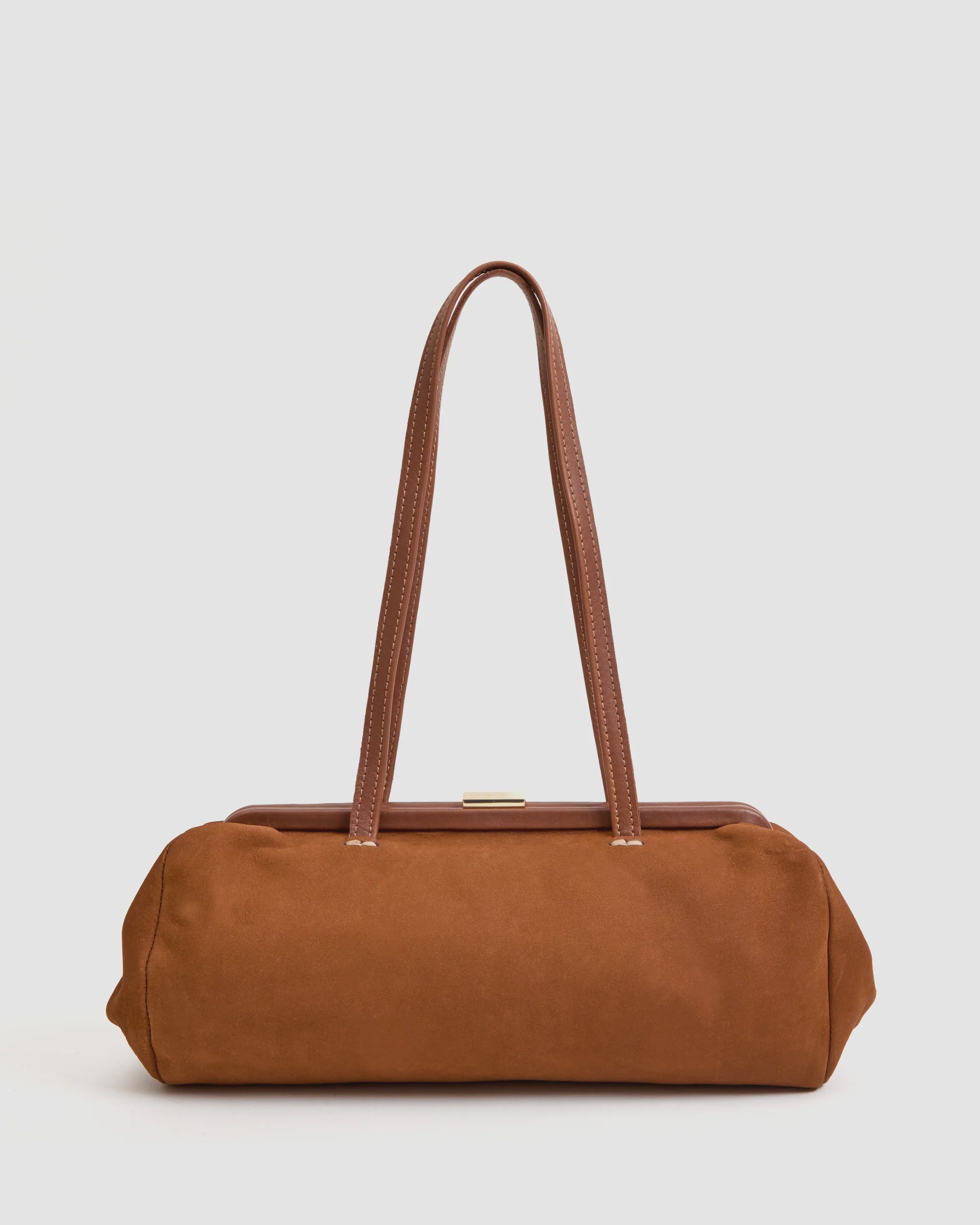 The Clare Vivier Yvette Smooth Nubuck is a rectangular brown suede shoulder bag with long matching straps and a structured top frame, shown here against a plain light background.
