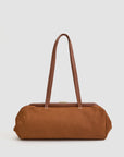 The Clare Vivier Yvette Smooth Nubuck is a rectangular brown suede shoulder bag with long matching straps and a structured top frame, shown here against a plain light background.