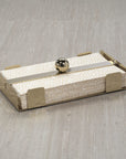 The Zodax Dinner Napkin Holder Gold displays a stack of white napkins with gold dots. This chic bar accessory, featuring a round gold ball on top, sits stylishly on a light wood surface.