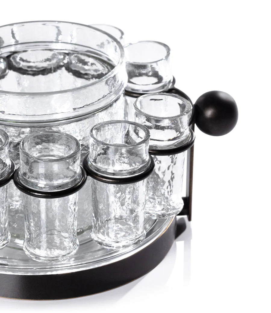 The Zodax Ten Shot Tequila Set w/Ice Bucket includes clear textured shot glasses in a circular black metal holder with handle, centered around a matching glass ice bucket—perfect for stylish tequila serving.