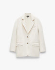 The Rag & Bone Zoe wool blazer is cream-colored with long sleeves, notch lapels, a relaxed fit, two black buttons, front flap pockets, and a chest pocket, shown against a plain white background.