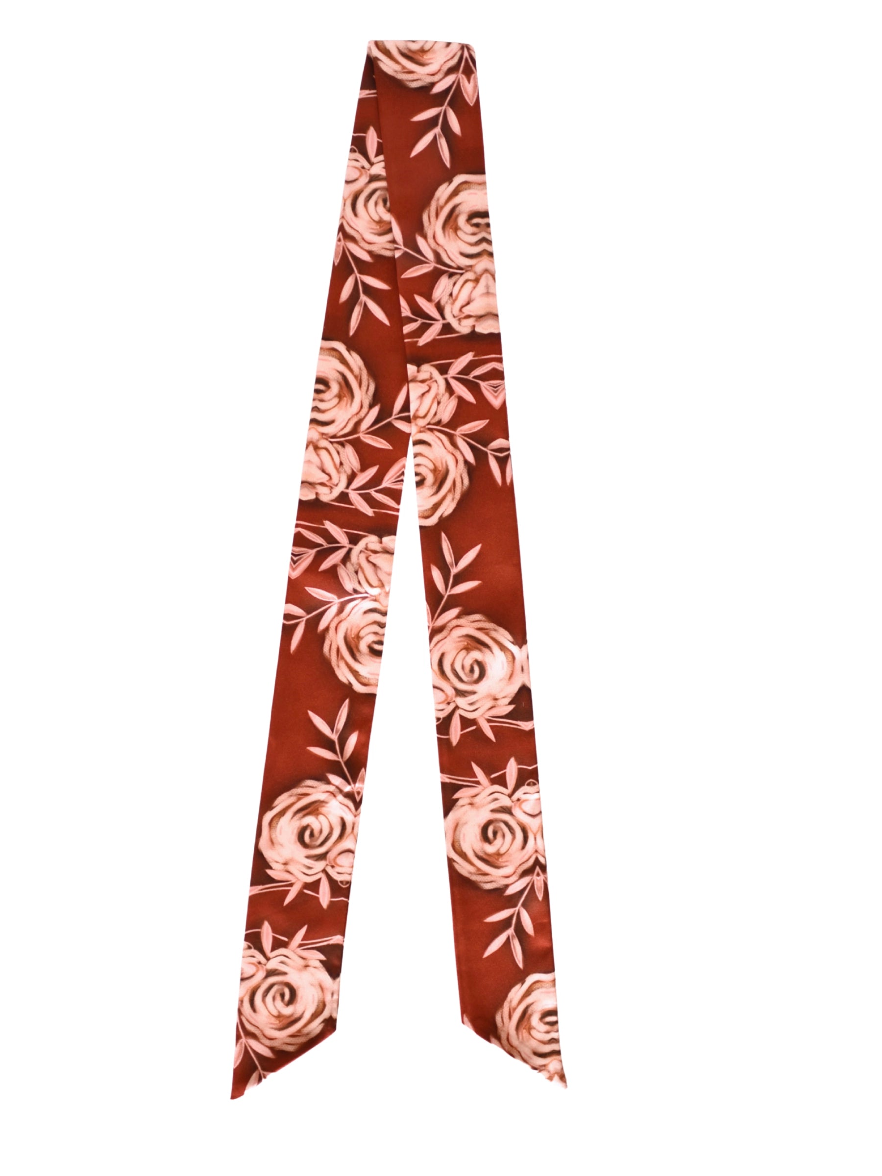 The Rustic Wild Rose Twilly Scarf by Faire is a long, narrow silk accessory with pointed ends, showcasing a hand-drawn pink rose and leaf design on a reddish-brown background.