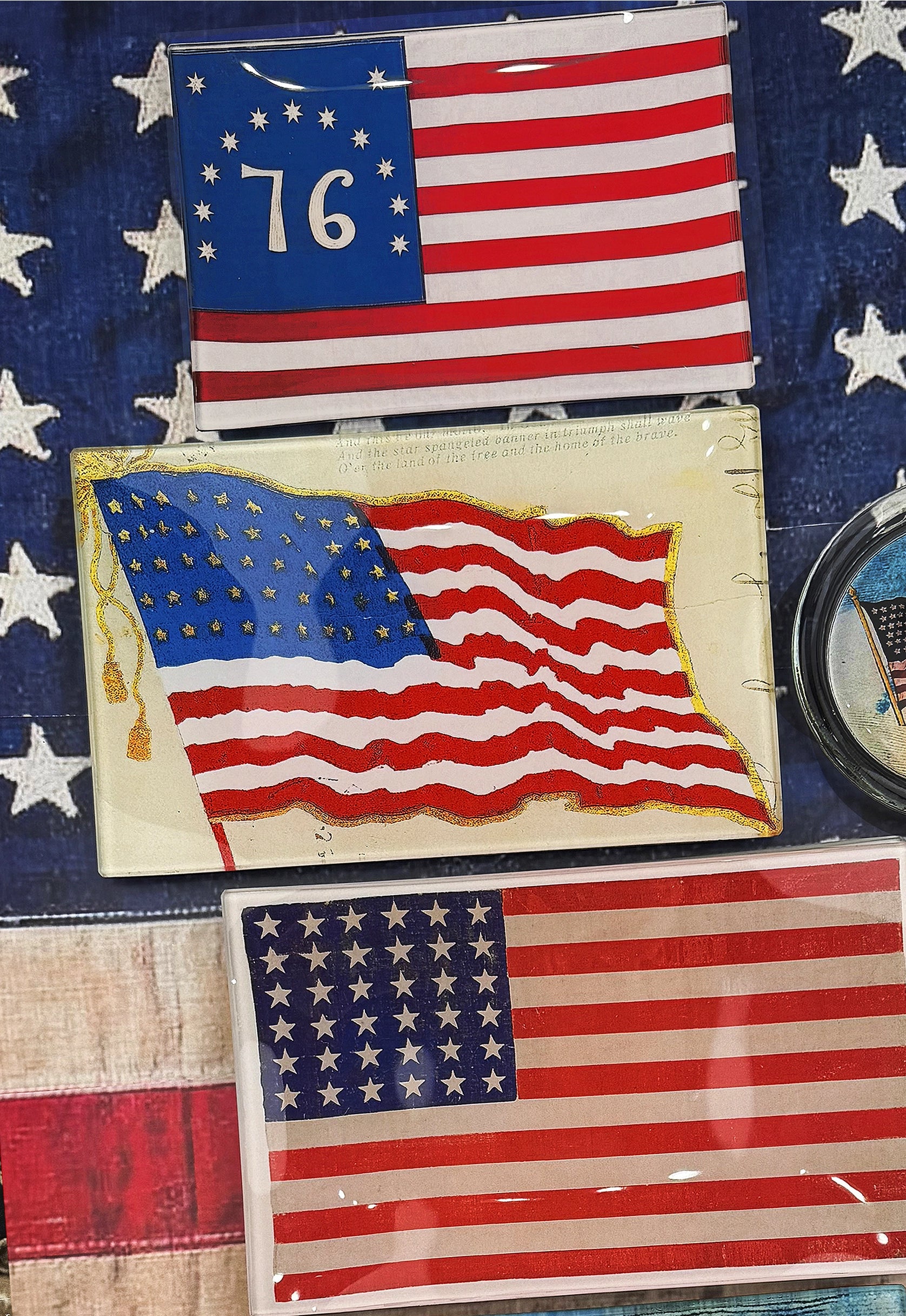 The Betsy Ross American Flag Glass Tray by Faire features vintage flag art with white stars, making it a striking piece of historical American decor perfect for display or découpage.