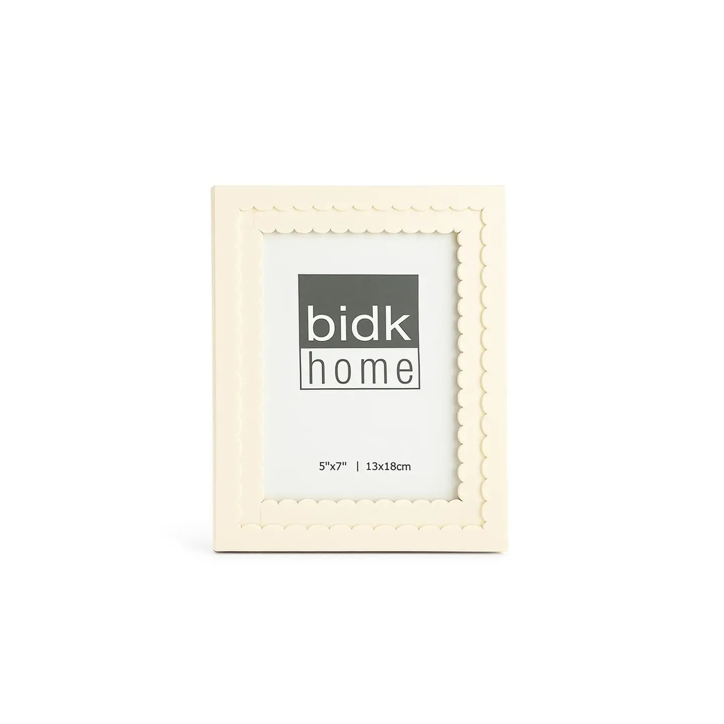 The BIDK Home 5x7 Floral Resin Frame features a cream hue and scalloped edge, made from premium resin. Displayed upright with a &quot;bidk home&quot; placeholder image, it&#39;s perfect for adding elegance to any home decor.
