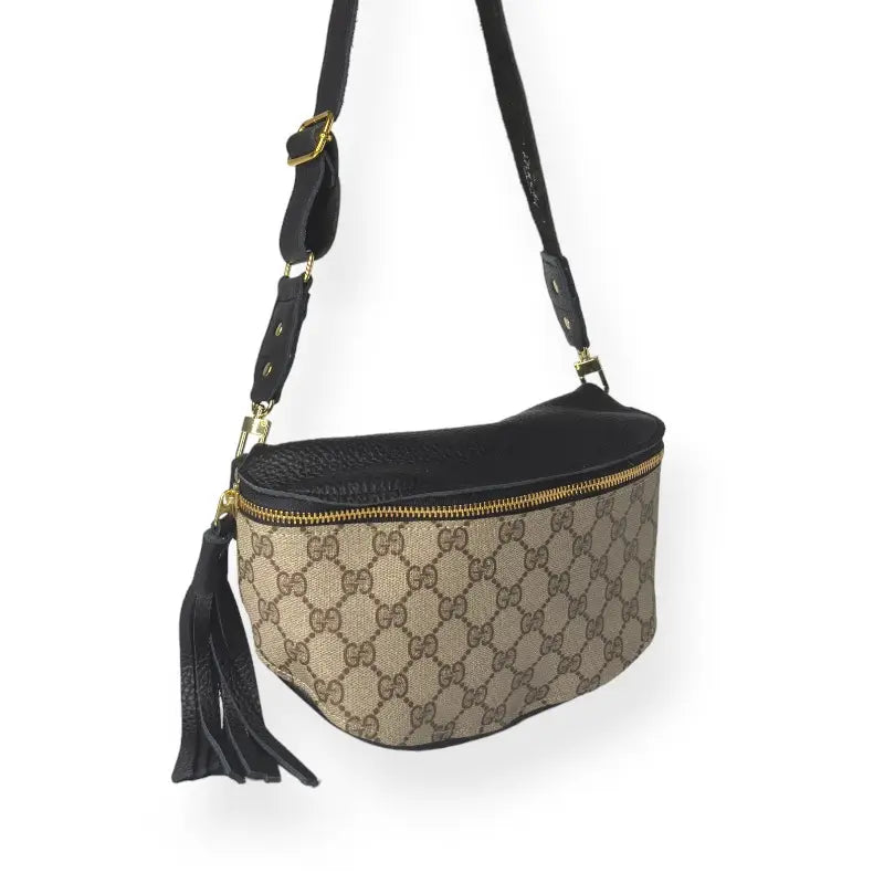 A beige and brown Faire Upcycled Belt Bag with black leather accents, gold-tone hardware, zip closure, and black tassel. This stylish designer purse showcases the signature GG monogram pattern for a timeless look.