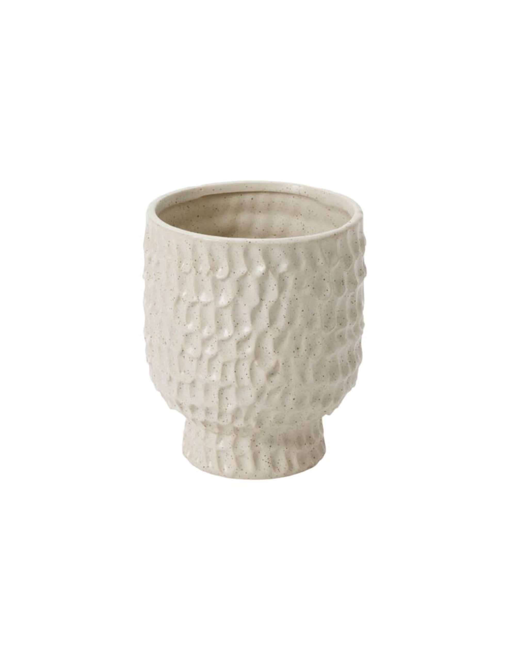 The Accent Decor 91746 Adrien Pot features a textured dimpled ceramic surface in light beige, with a rounded body and slightly flared base, evoking the look of classic stoneware.