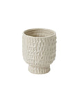 The Accent Decor 91746 Adrien Pot features a textured dimpled ceramic surface in light beige, with a rounded body and slightly flared base, evoking the look of classic stoneware.
