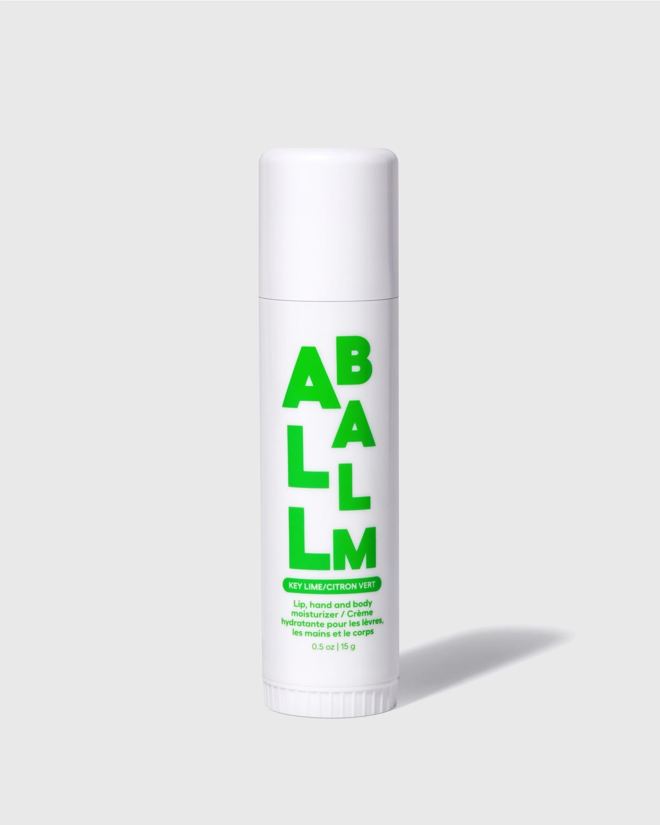 A white tube featuring bold green "ALL BALM" text on a gray background showcases its Key Lime/Citron Vert scent. Designed for lips, hands, and cuticles, the Faire All Balm Stick provides non-greasy hydration and long-lasting moisture with natural ingredients.