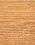 Close-up texture of light brown wood grain, showing natural lines and patterns on a smooth, Bloomingville bungalow-style wooden surface.