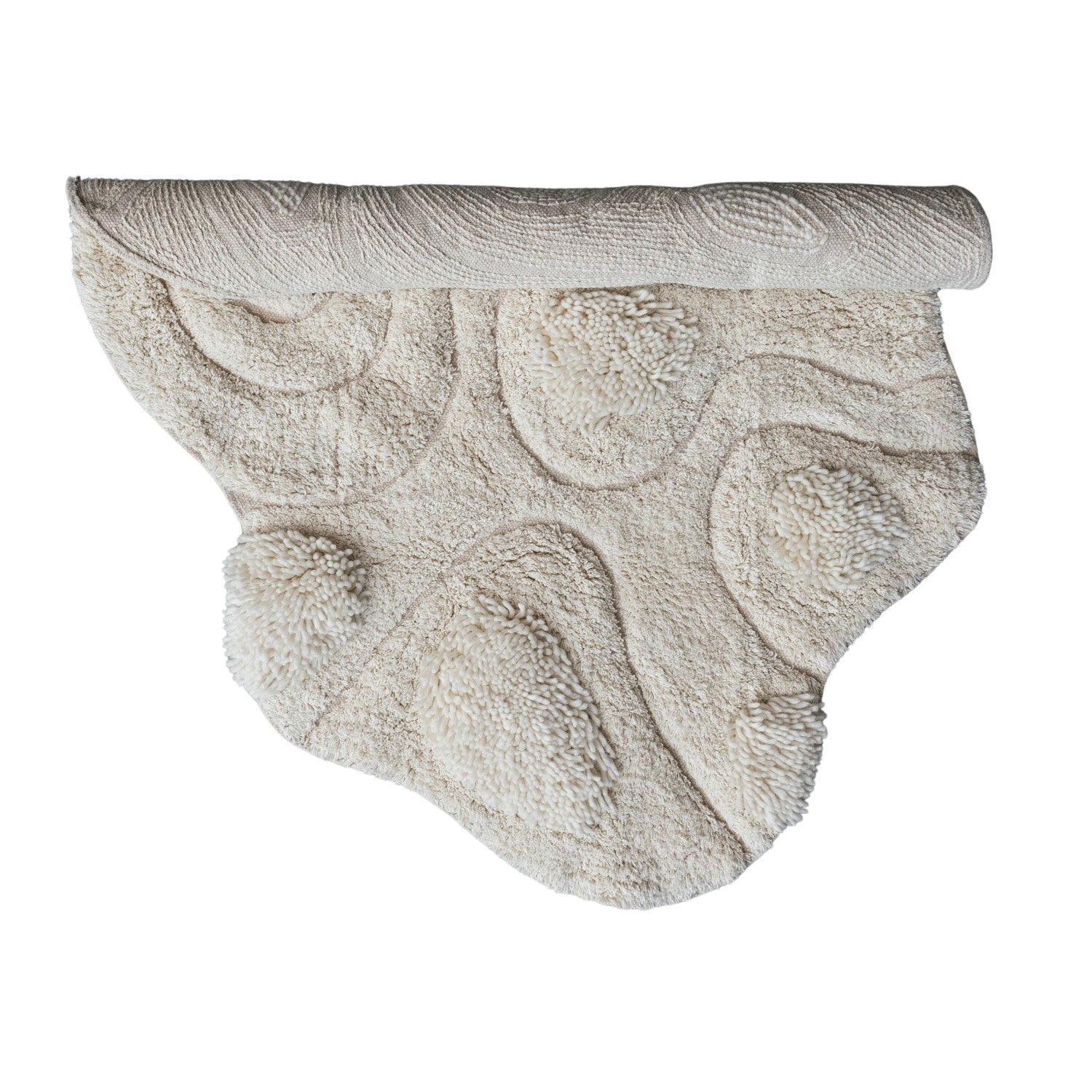 The Bloomingville 3'x3'8" tufted rug features a beige, irregular shape with raised textured patterns and abstract curves, shown partially rolled on a white background.