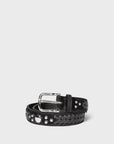 The Gaucho Ceinture belt by Jerome Dreyfuss features black cowskin leather with a silver buckle, blending braided and studded details. This adjustable accessory is rolled up against a plain white background.