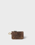 The Popoche XS Pouche by Jerome Dreyfuss is a small goatskin pouch in leopard print, featuring a top zipper, a gold carabiner clip on the side, and a convenient key fob. It also has four gold rivets on the front corners against a plain white background.