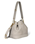 The Ben Small Bucket by Jerome Dreyfuss is a light gray calfskin handbag with gold hardware, featuring a structured shape, leather shoulder strap, and front flap for easy wearing. Its design is simple and elegant.