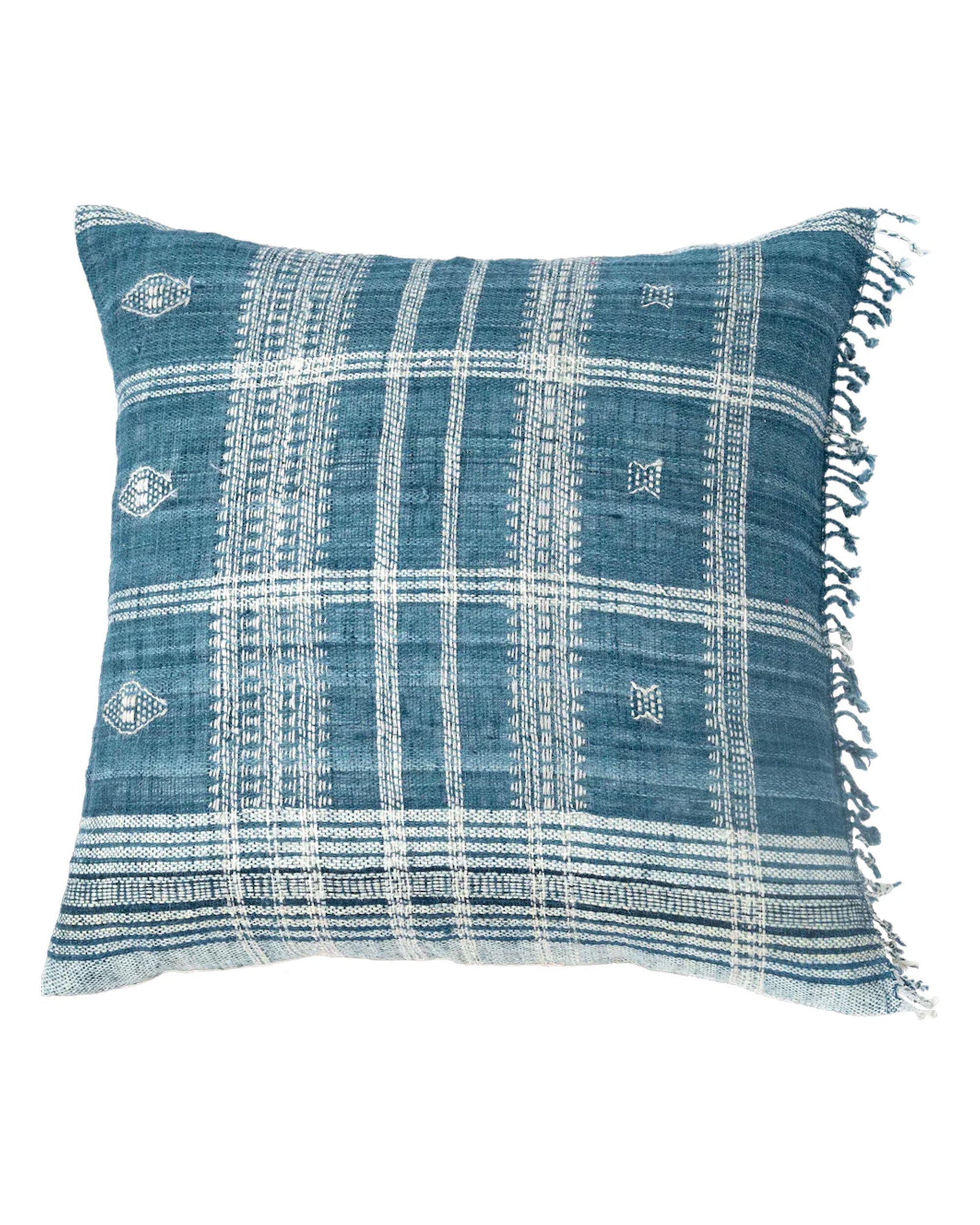 The Anika Positano Pillow 24x24 by Filling Spaces LLC is a square blue, naturally dyed wool pillow with white geometric patterns and right-side fringe.