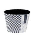 The Amador Tall Planter by The Import Collection features a black and white checkered tapered design, decorated with iron resin and a side pattern that transitions into rectangular marble-like tiles.