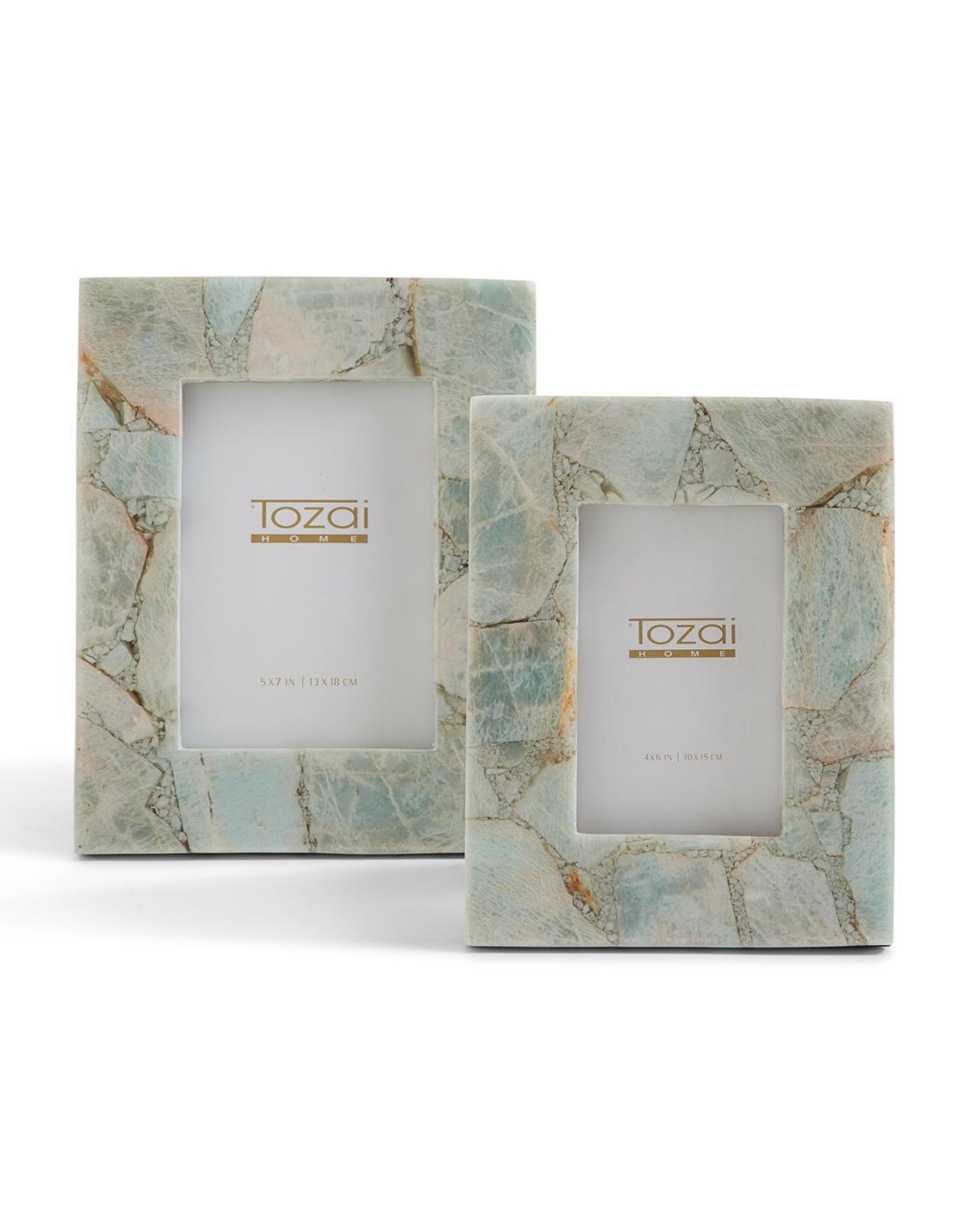 The HCM020-AZS2 Amazonite Frames by Two's Company feature two rectangular frames with light blue and beige marble patterns, inspired by amazonite. Each unique frame displays a "Tozai Home" logo card and stands upright on a white background.