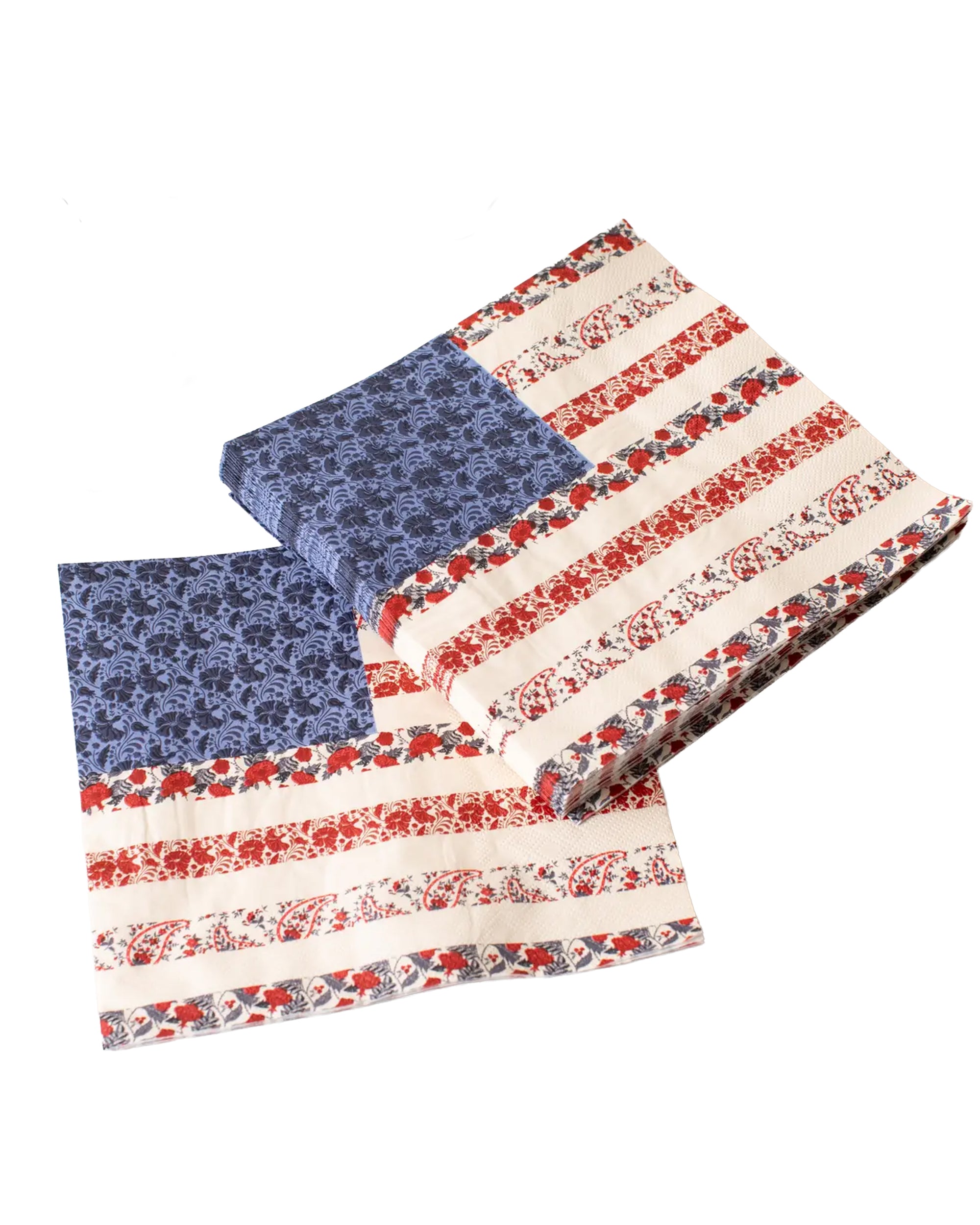 Faire’s Americana Flag Paper Napkins, featuring blue floral corners and red-and-white floral stripes, are displayed on a white surface.