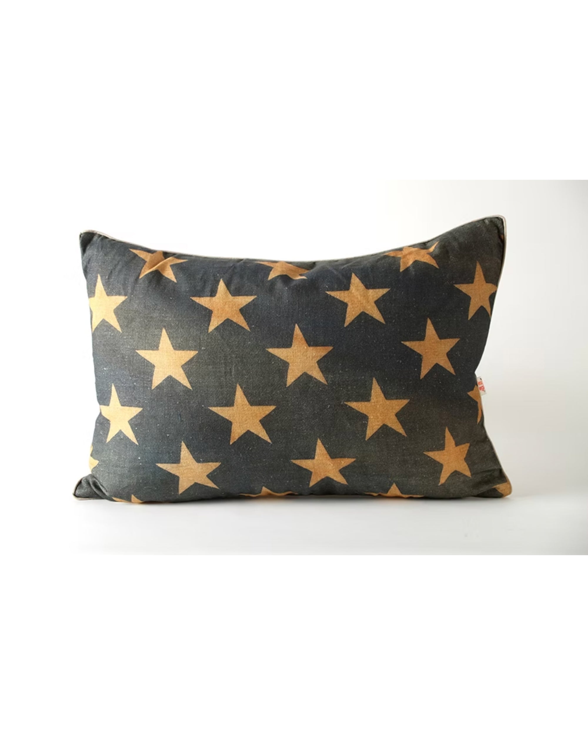 The Design Legacy Nat Old Glory Stars 17x24 pillow features large, evenly spaced gold stars on a rectangular cushion, offering a touch of subtle patriotism against a crisp white background.