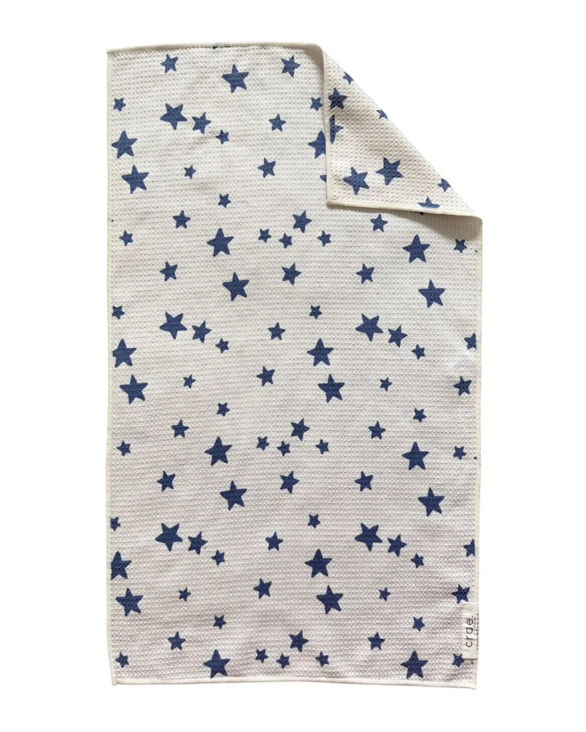 White waffle weave hand towel with blue stars, folded; Annie by Faire, perfect for modern or guest bathrooms.