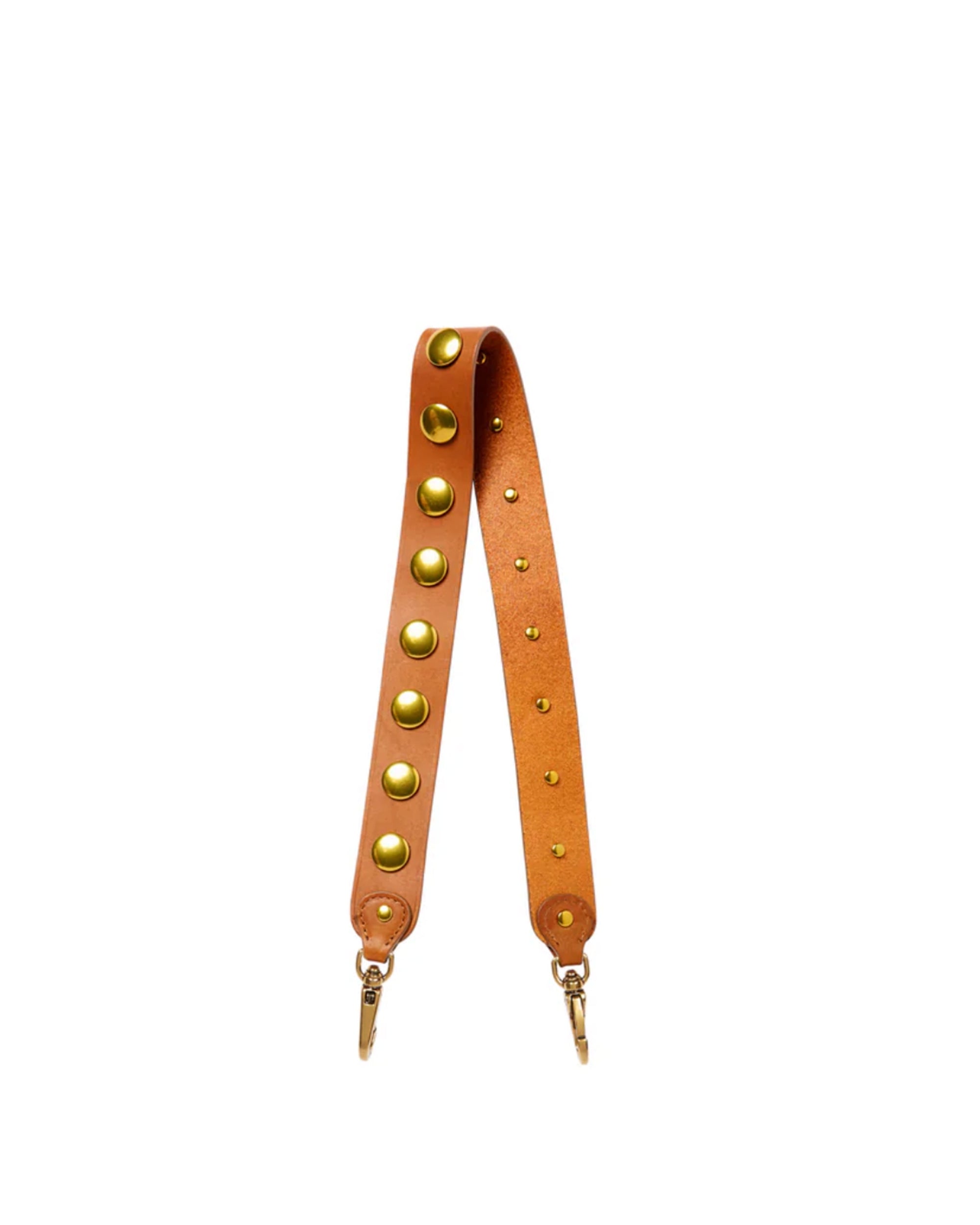 The Anse Festival Strap by Jerome Dreyfuss features genuine vegetable-tanned cowskin in tan, adorned with large gold metal studs and secure clasps at both ends, shown on a plain white background.