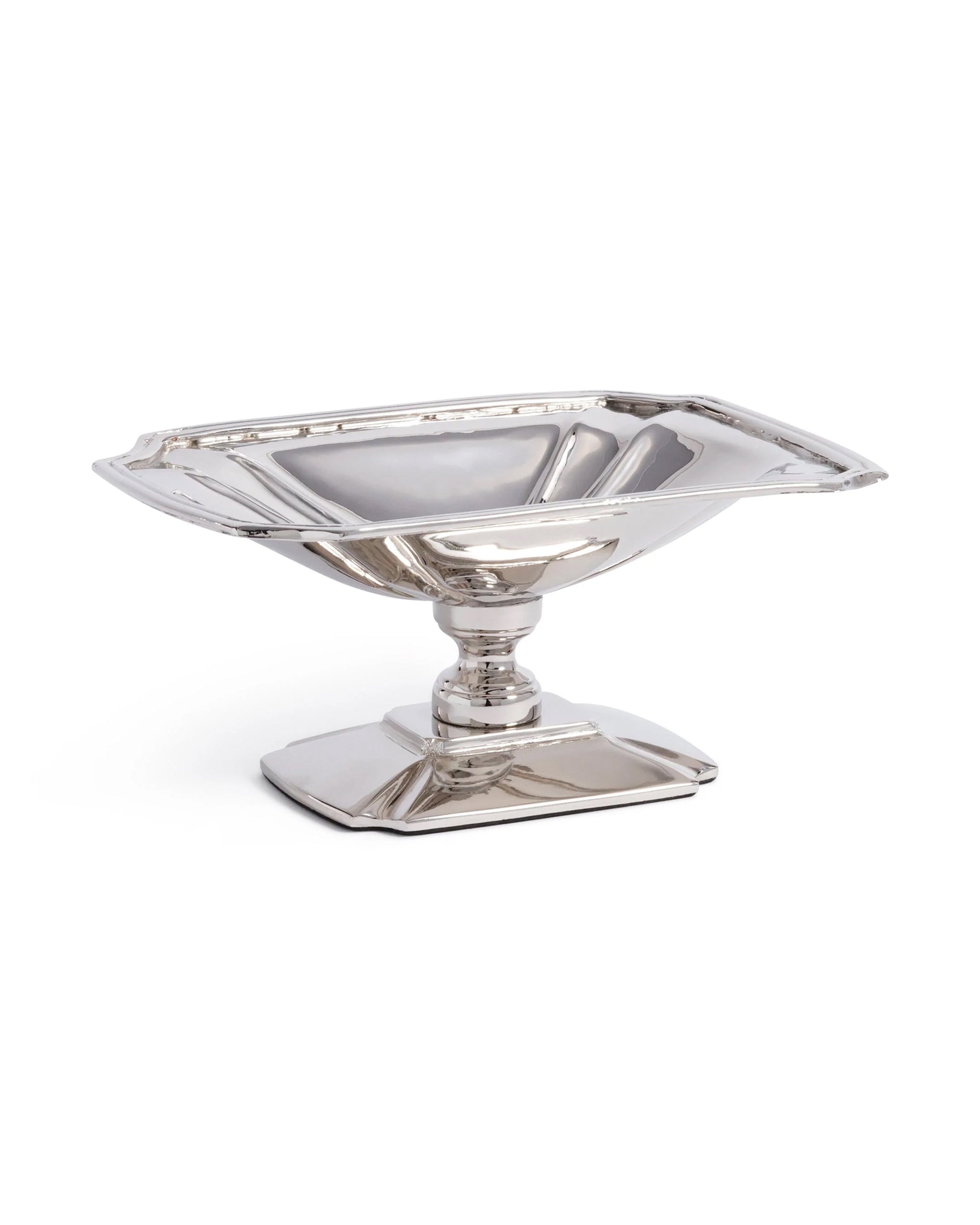 The Zodax Antique Footed Dish features a wide, shallow bowl on an ornate rectangular base. Its polished nickel finish creates a gleaming, reflective surface for an elegant display.