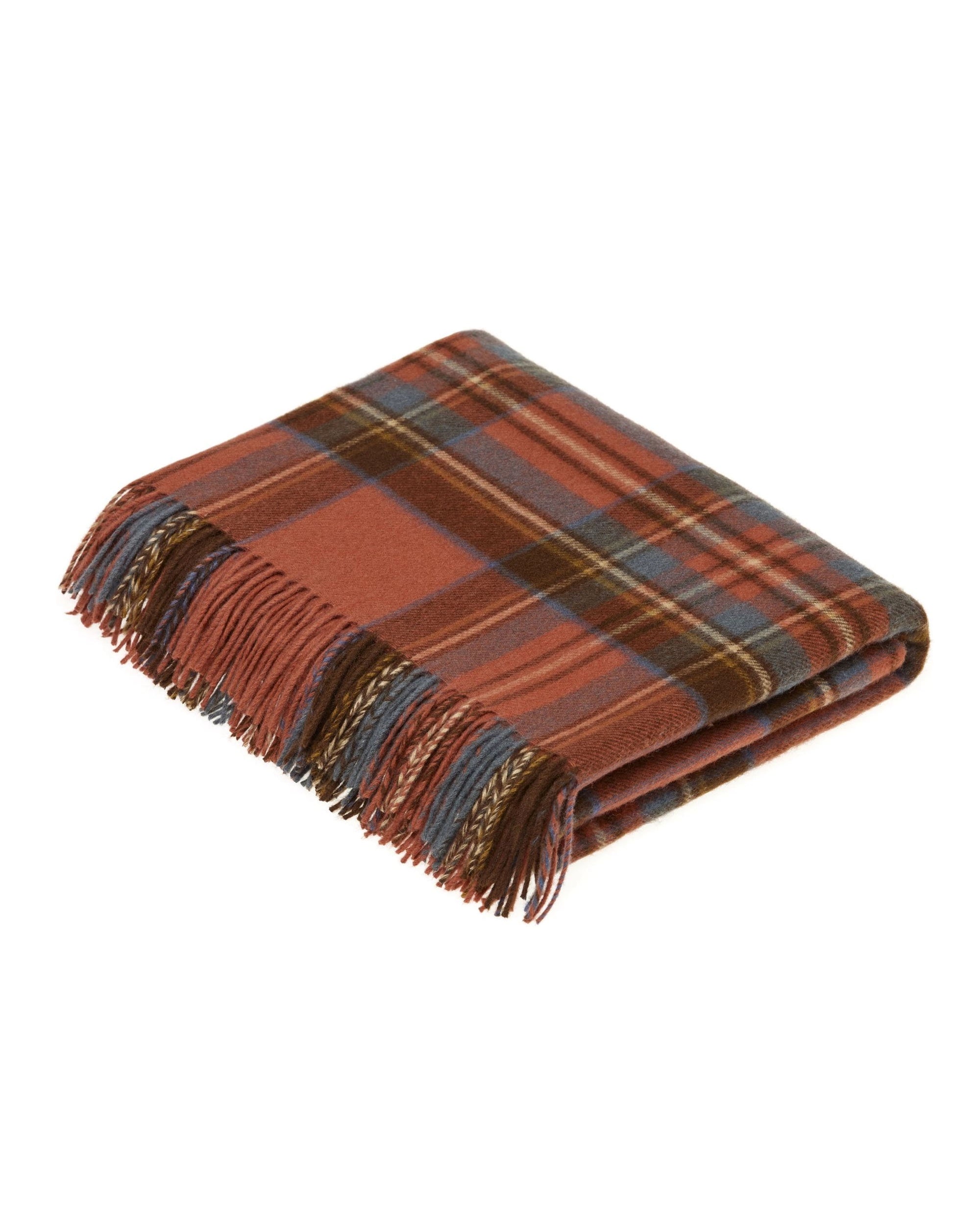 The Faire BM Merino Lamb Throw/Blanket features a folded, fringed tartan design in rust, blue, brown, and beige, crafted from soft Merino Lambswool and inspired by traditional clan patterns.