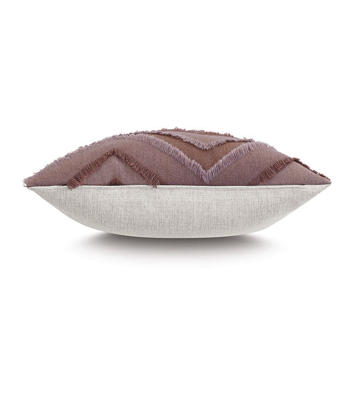 The REINHART FRINGE pillow by Eastern Accents measures 24x24 and features a light beige bottom, textured mauve chevron top with zigzag pattern, and fringed edges, shown from a side view.