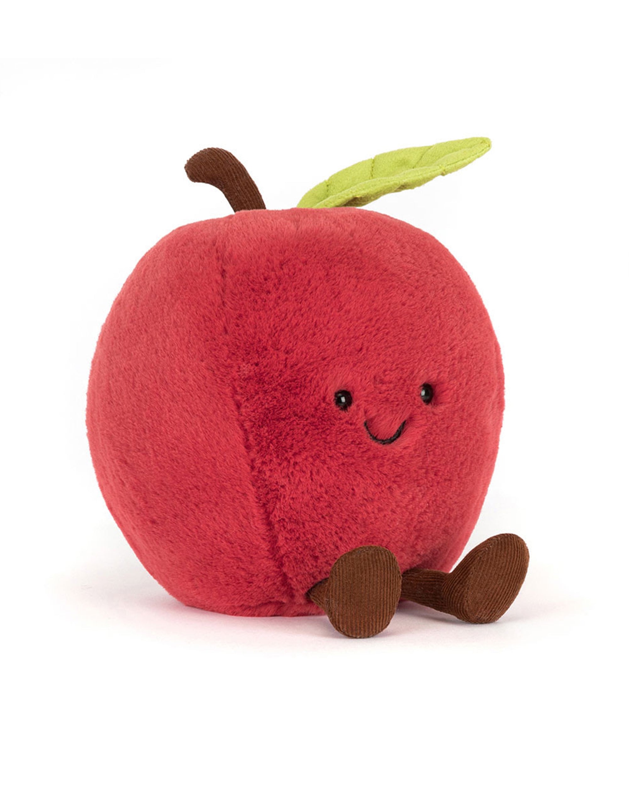 The Amuseables Apple by Jelly Cat Inc. is a plush red toy with a smiling face, brown stem, green leaf, and brown arms and legs, shown sitting upright against a white background.
