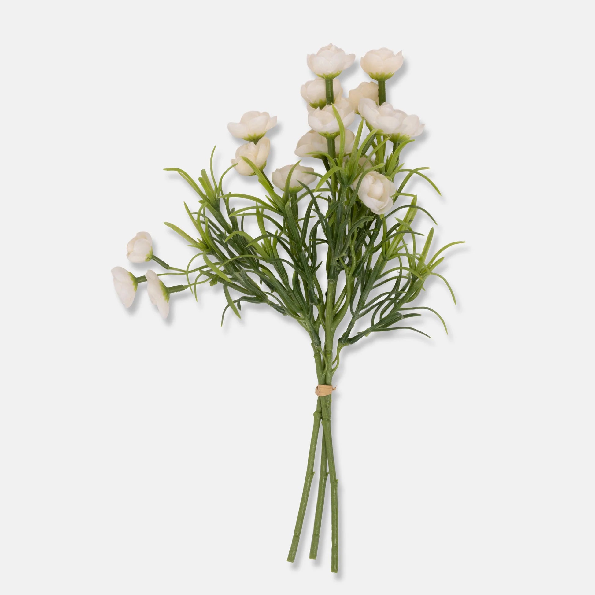 The Hellebore Bunch in White by Abigail Ahern features small white artificial flowers with green stems and leaves, secured with a light brown rubber band and displayed against a plain white background.